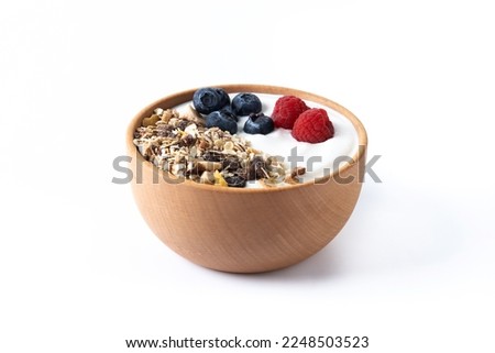 Yogurt with berries and muesli for breakfast in bowl.  Royalty-Free Stock Photo #2248503523