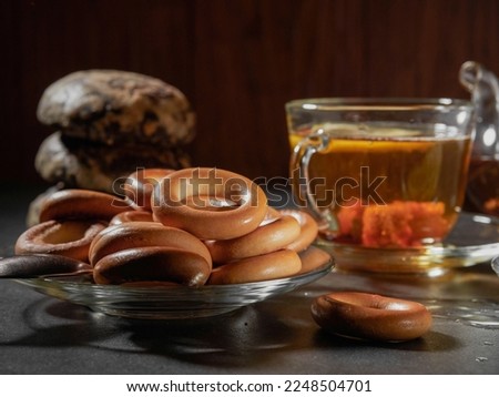 a cup of hot tea with lemon and bagels  