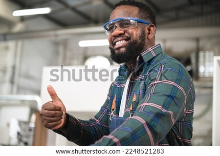 Portrait African American carpenter thump up at wood factory	 Royalty-Free Stock Photo #2248521283