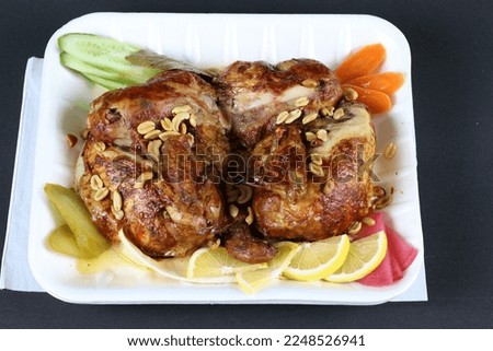 Grilled Chicken Meal with Nuts and Slices of Carrots Lemons Cucumbers Peppers and Pickles  Meat Dishes Stock Photos 2