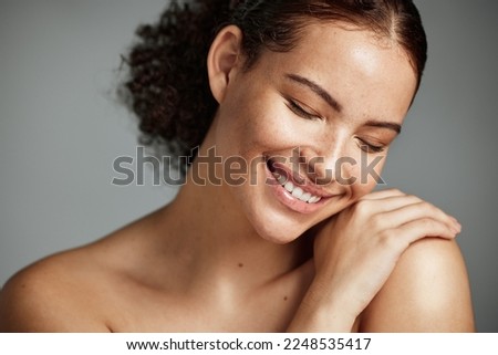 Face, beauty and skin with a model black woman in studio on a gray background to promote natural care. Facial, wellness and makeup with an attractive young female happy with her skincare product
