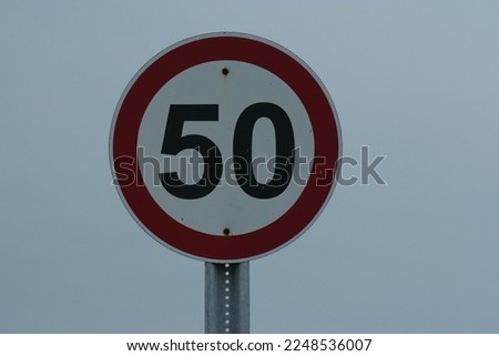 50 km speed sign, gray sky