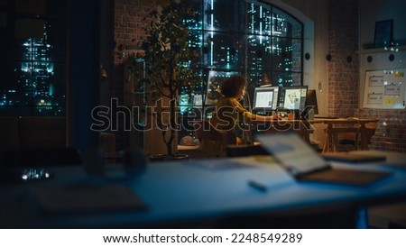 Successful Arab Female Sitting in Creative Agency Alone in the Evening, Manager Working on Implementing Business Strategy for Client. Excited Specialist Writing Corporate Project Plans on Computer.