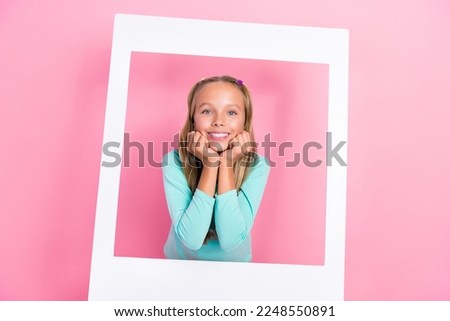 Portrait of positive adorable schoolchild hands touch cheeks toothy smile paper album card isolated on pink color background Royalty-Free Stock Photo #2248550891