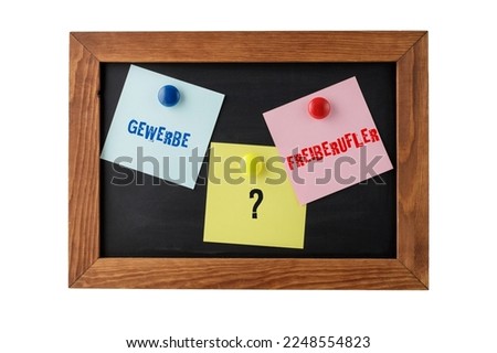German words Gewerbe and Freiberufler (eng. business and freelance work) on colorful notepapers on magnetic blackboard isolated on white. Choosing between opportunities for own financial independence.