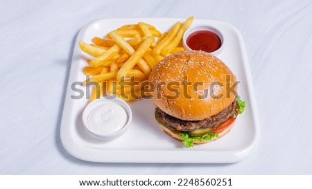 Beef burger, french fries in white tray