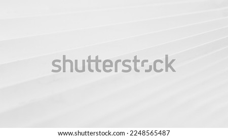 Minimalistic white dynamic background with diagonal lines, curtains, abstract dark geometric shape from fabrics with soft shadow background, top view	