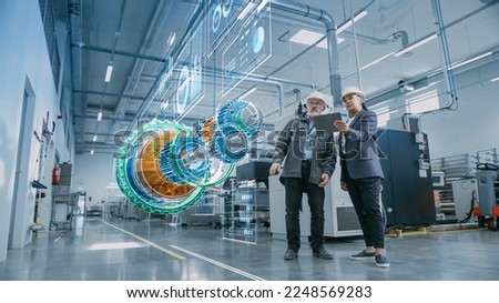 Factory Digitalization: Two Industrial Engineers Use Tablet Computer, Analysing Data about a 3D Model of Green Energy Engine. Industry 4 High-Tech Electronics Facility with Manufacturing Products