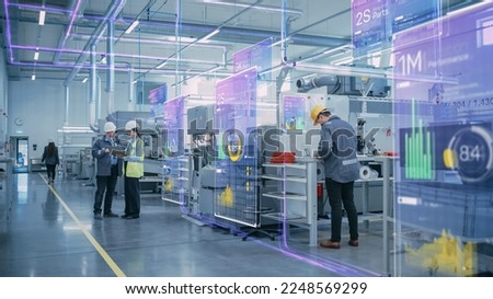 Factory Digitalization: Two Industrial Engineers Use Tablet Computer, Big Data Statistics Visualization, Optimization of High-Tech Electronics Facility. Industry 4.0 Machinery Manufacturing Products Royalty-Free Stock Photo #2248569299