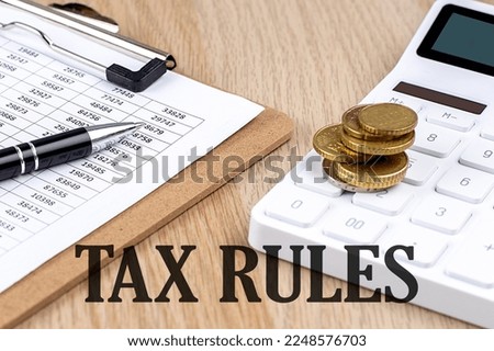 TAX RULES text with chart and calculator and coins , business