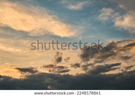Gorgeous gloomy sky at sunset, contrast of black storm clouds and sky, idea for a background