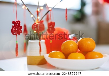 Decorated flat putting traditional pendant to the red Chinese New Year Celebrations for good luck. chinese word means blessing.