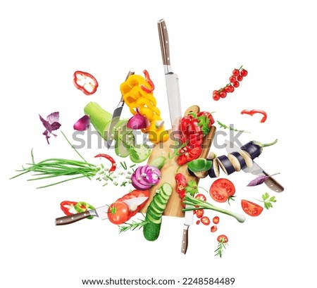 Vegetables fall on the board and cut with a knife isolated on white background