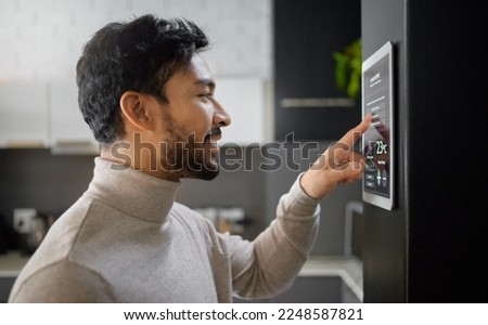 Smart home technology, wall system and man with digital ui monitor for thermostat heating, safety security network or air conditioning. AI software app, house automation or profile of person with IOT Royalty-Free Stock Photo #2248587821