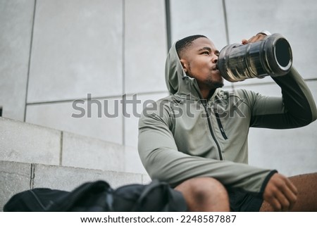 Fitness, relax or black man drinking water in training or exercise for body recovery or workout in Chicago, USA. Hydration, thirsty or tired healthy sports athlete drinks natural liquid in bottle Royalty-Free Stock Photo #2248587887