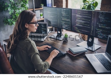 Photo of smart concentrated lady web designer write key words download media database upgrade modern device indoor room workstation