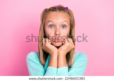 Closeup photo of young cute pretty schoolgirl pouted lips touch cheeks look you dreamy interested concentrated isolated on bright pink color background