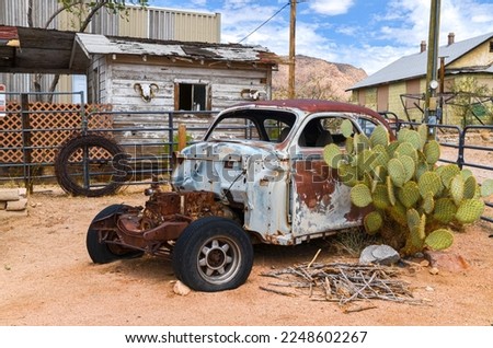 broken rusty car and big cactus in Hackberry on historic Route 66 (Mohave county, Arizona) Royalty-Free Stock Photo #2248602267