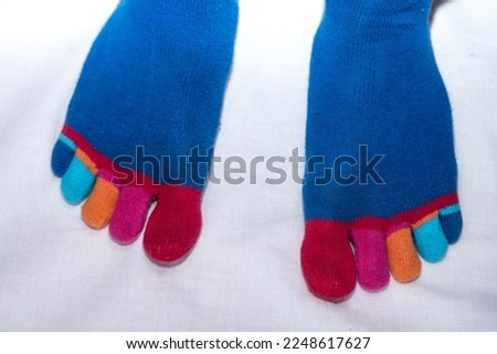hand-knitted socks with toes of different colors - croped image