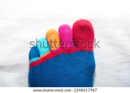 funny brightly colored toes of hand knitted sock - close up
