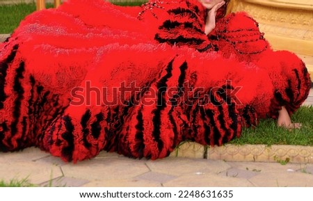 A beautiful little model posing in a very beautiful chic dress