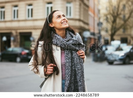 Walking, city buildings and happy woman on outdoor travel adventure in sidewalk street, road or journey In Chicago Illinois. Urban architecture, beauty and girl smile on winter vacation tour in USA Royalty-Free Stock Photo #2248658789