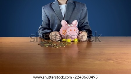 businessman child in a suit holding piggy bank. Financial education, savings for kids concept. High quality photo