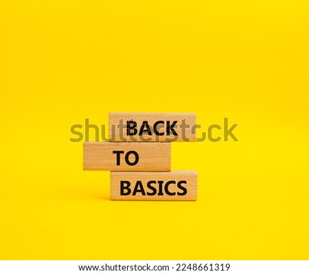 Back to basics symbol. Concept word Back to basics on wooden blocks. Beautiful yellow background. Business and Back to basics concept. Copy space