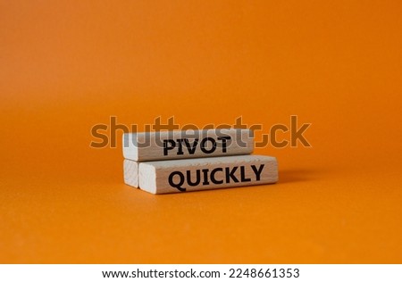 Pivot quickly symbol. Wooden blocks with words Pivot quickly. Beautiful orange background. Business and Pivot quickly concept. Copy space.