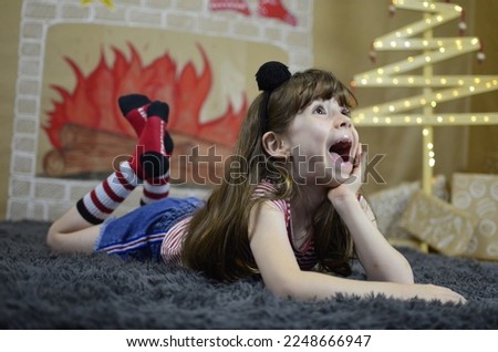 xmas photoshoot with girl and teddy bear on a draw backdrop