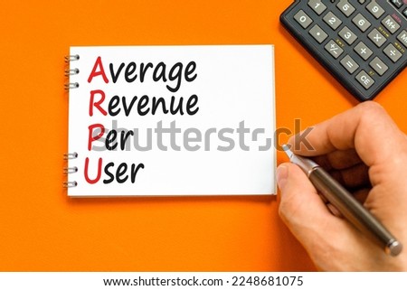 ARPU average revenue per user symbol. Concept words ARPU average revenue per user on white note on beautiful orange background. Business ARPU average revenue per user concept. Copy space.