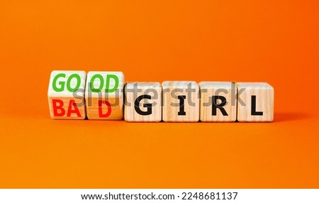 Good or bad girl symbol. Concept word Good girl Bad girl on wooden cubes. Beautiful orange table orange background. Business psychological good or bad girl concept. Copy space.