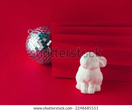 2023. Chinese New Years greeting card with white rabbit and disco ball on isolated dark red background. Happiness and best wishes idea. Holiday decoration and celebration concept. Chinese Zodiac sign.