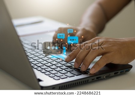 Online live chat chatting on application communication digital media website and social network concept, Close-up hands typing on keyboard laptop computer with chat box icons.