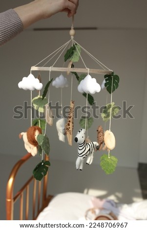 children's mobile for a bed in the style of animals lion, giraffe, zebra. decor for a children's bed