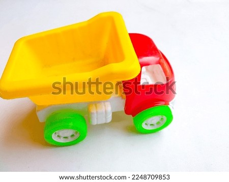 Close up of colorful sand truck toy on white background
