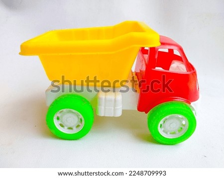 Close up of colorful sand truck toy on white background