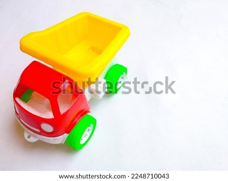 Close up of colorful sand truck toy on white background. Space for text