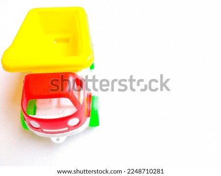 Close up of colorful sand truck toy on white background. Space for text
