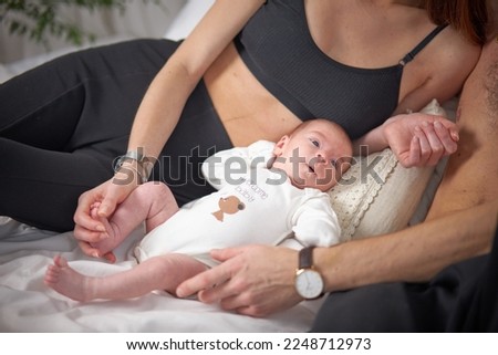 Happy young parents spend time with their little child. The concept of family and love. Family morning at home.