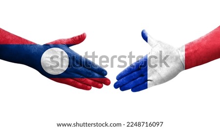 Handshake between France and Laos flags painted on hands, isolated transparent image.