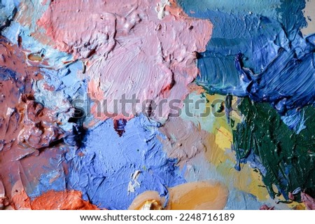 Colorful abstract texture. Smears of oil paint on an art palette. The concept of the modern school of art. Fragment of creative work. Colors of the year 2023.