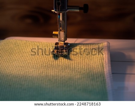 Electric sewing machine on a wooden background. Close-up.