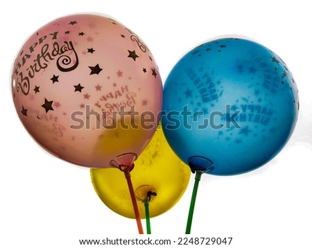 The 3 red yellow blue balloons that say happy birthday are loved by the children.