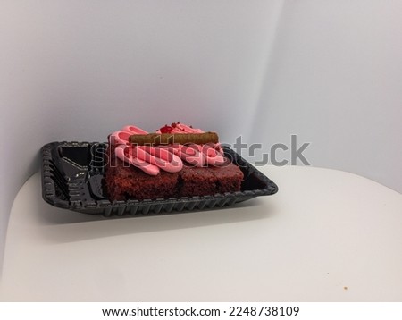 Delicious chocolate mousse flavor cake with vanilla and cream filling in a strawberry topping isolated on a white background with copy space