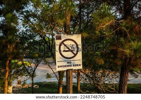 warning sign that reads "No Smoking Area".