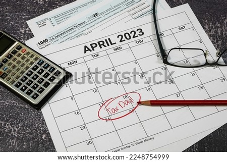 2023 US tax day calendar reminder with tax forms, calculator and glasses. Royalty-Free Stock Photo #2248754999