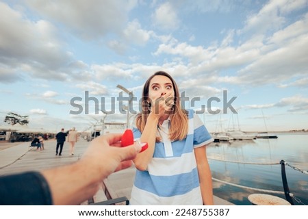 
Surprised Woman Receiving an Engagement Ring on Vacation
Happy girlfriend accepting a romantic marriage proposal
 Royalty-Free Stock Photo #2248755387