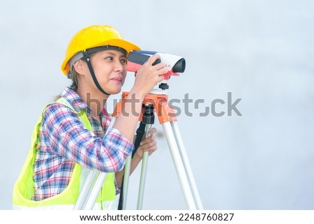 Female survey working Using Theodolite Surveying Optical Instrument for Measuring Angles in Horizontal and Vertical Planes on Construction Site. Royalty-Free Stock Photo #2248760827