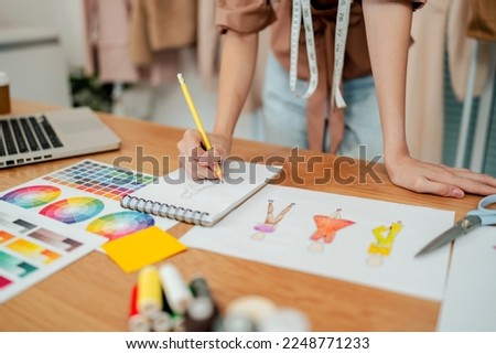 Fashion Designer Stylish Artist or creative designer drawing on sketch book with new project design